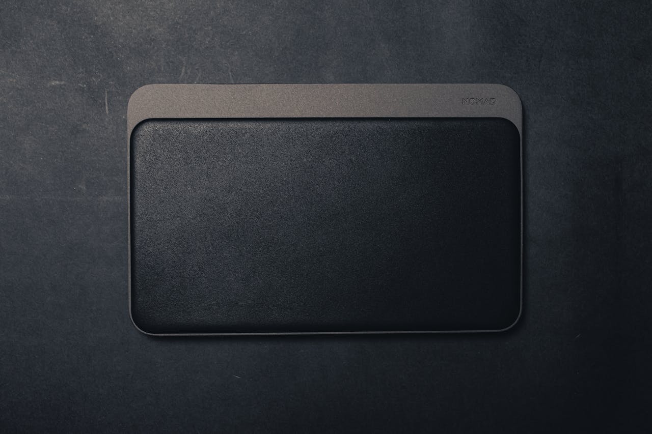 Sleek and stylish black leather textured mouse pad offering a minimalist design with ample copy space.